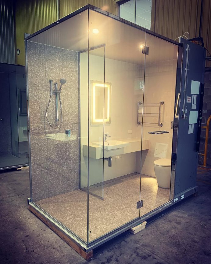 Prefabricated bathroom pod with lit mirror
