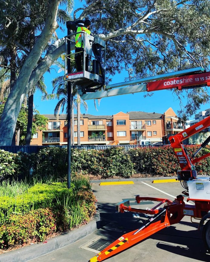 Electrician installing car park lighting from an elevated work platform