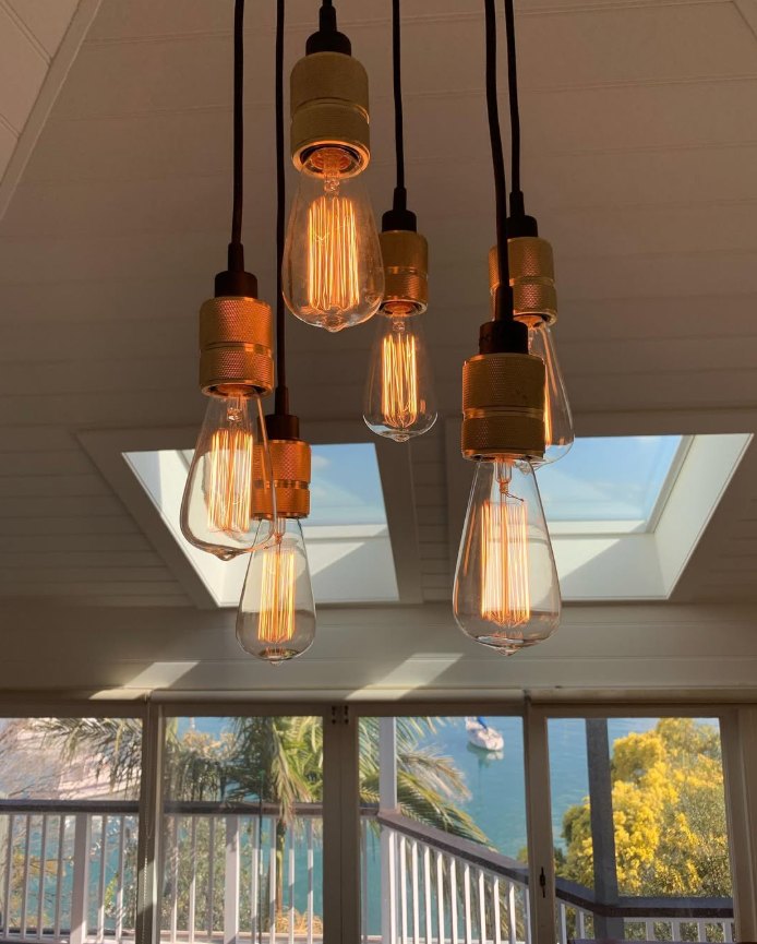 Cluster of filament pendant lights under a raked ceiling