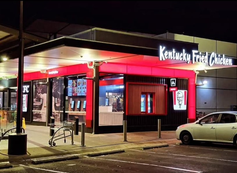 Restaurant storefront and signage lit at night
