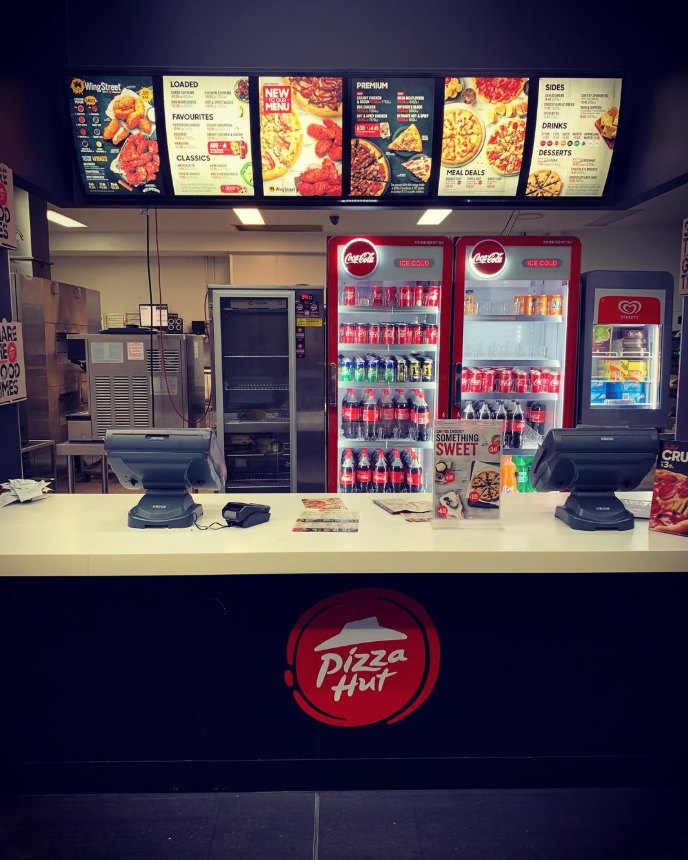 Takeaway store counter with illuminated menu boards