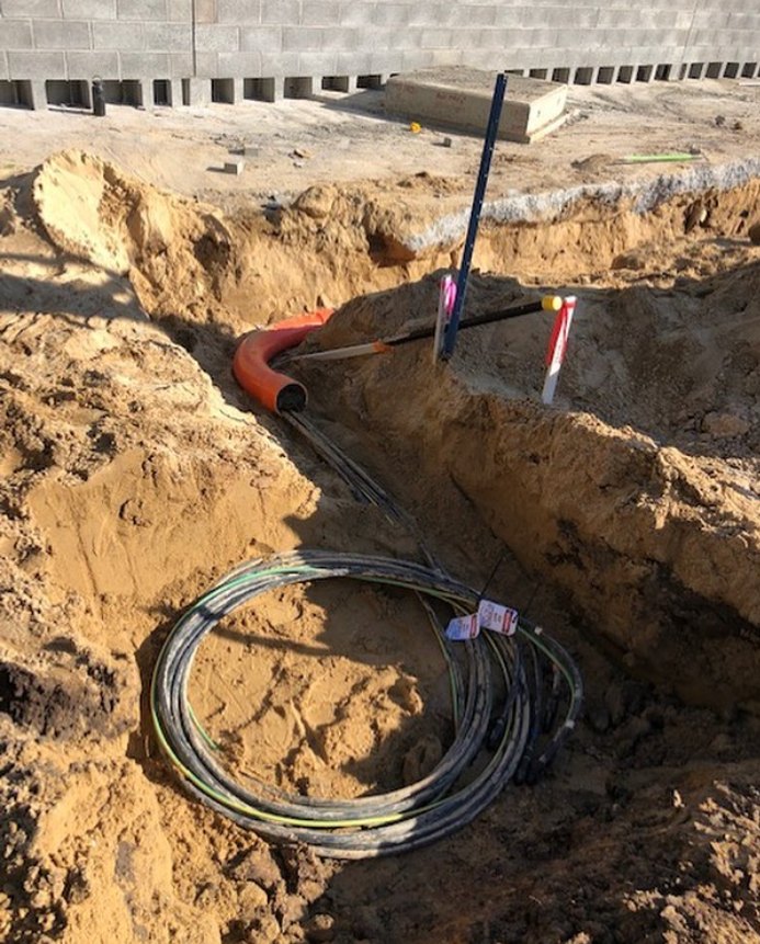 Underground cabling and conduit laid in an open trench